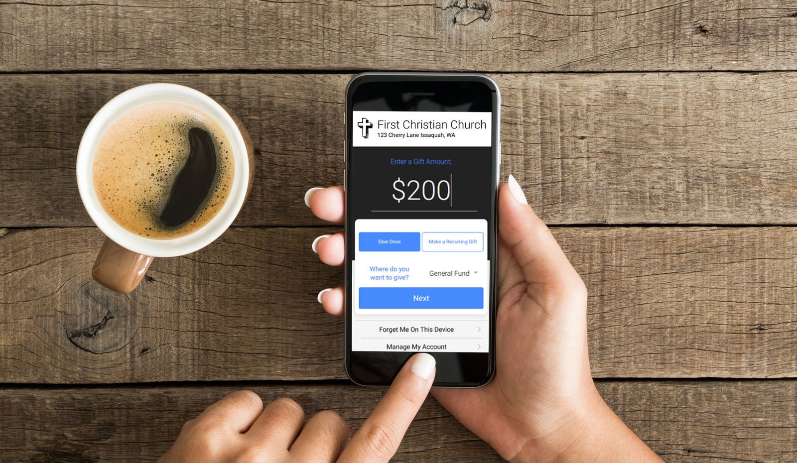 A person entering a $200 gift to the general fund on Givlia's mobile giving screen, next to a cup of coffee.