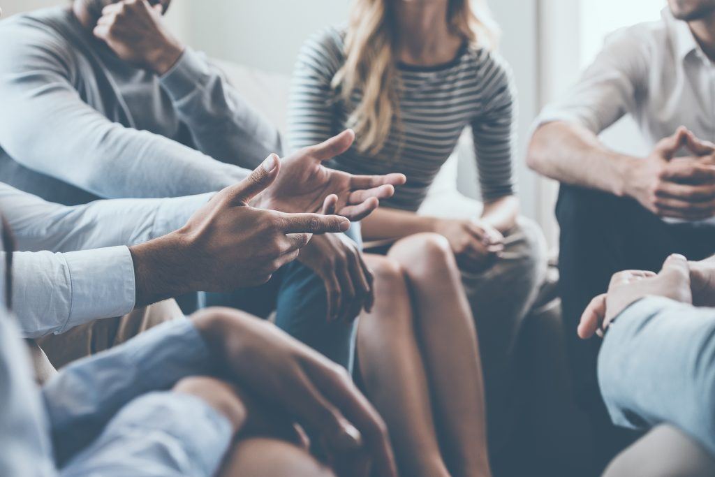 A small group sitting in a circle, deep in conversation.